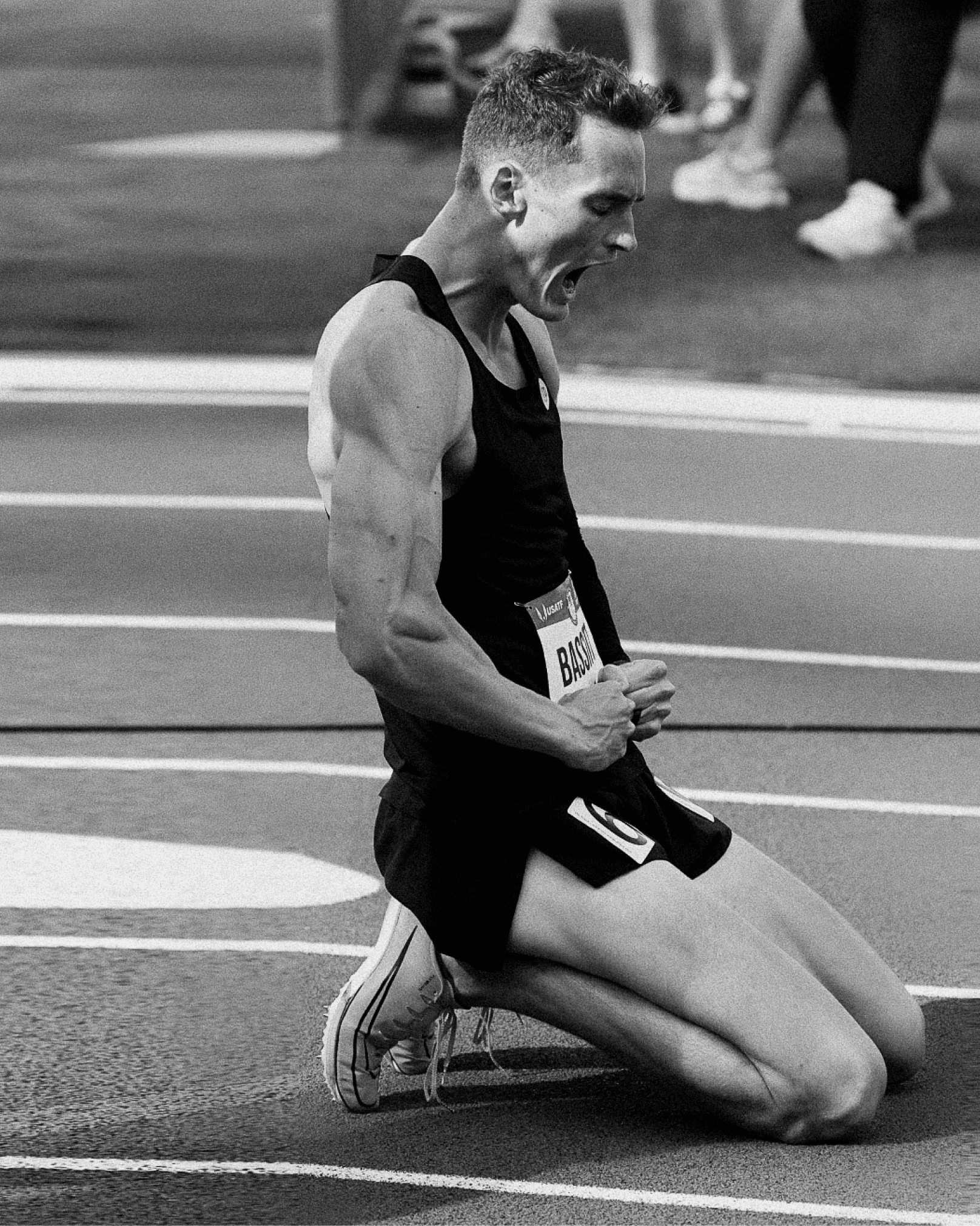 Black and white: Trevor Bassitt on his knees on the track, fists clenched, shouting, after making the 2024 Olympic team in the 400m hurdles