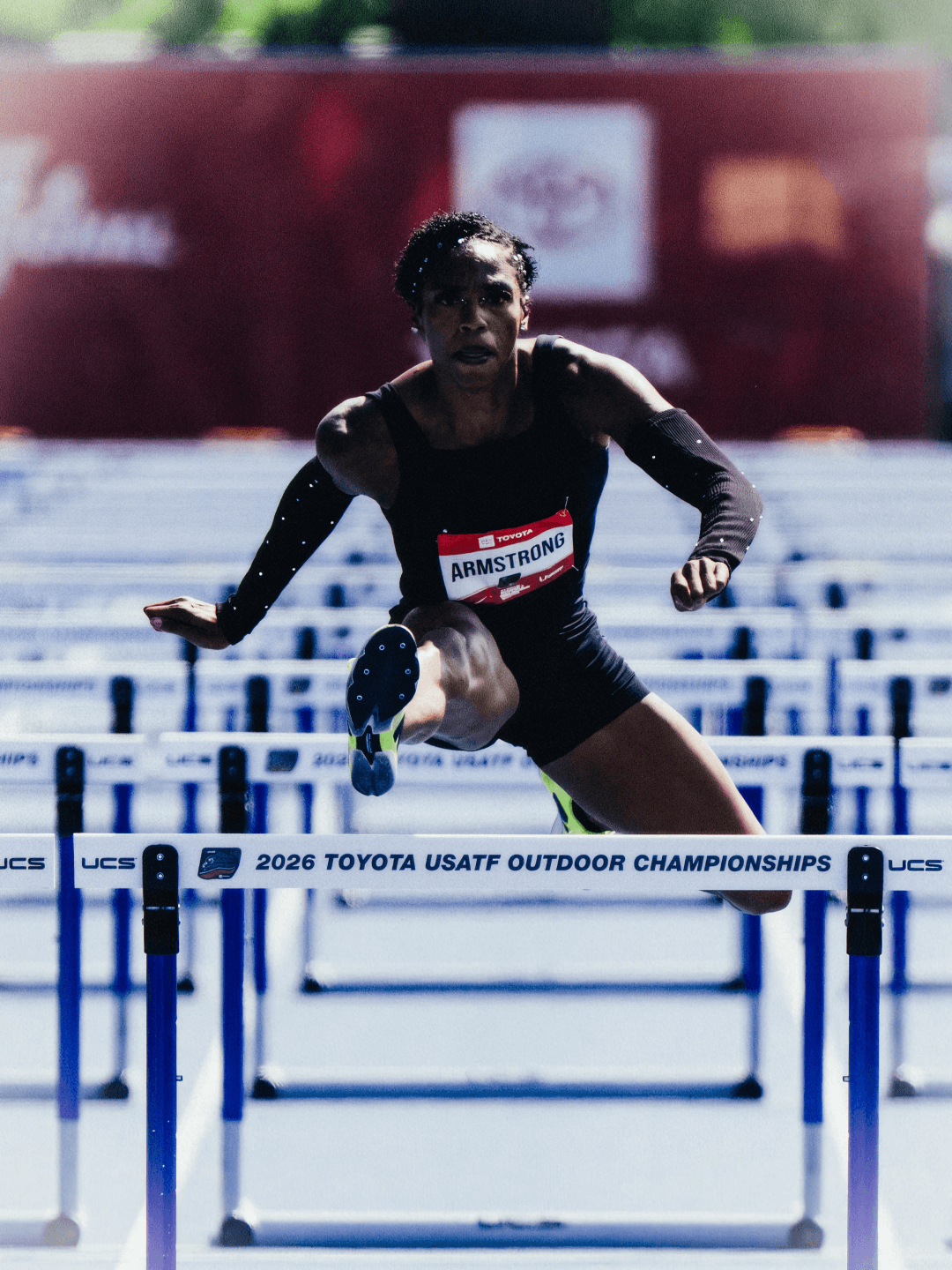 Armstrong clears a hurdle, the rail lettered 2026 Toyota USATF Outdoor Championships