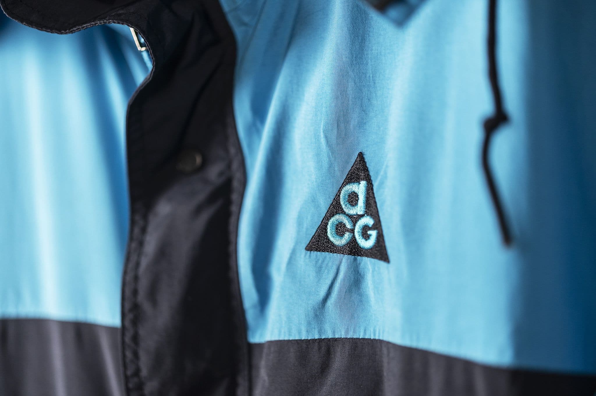 The original ACG triangle embroidered in teal on the chest of a black and turquoise 1989 Huascaran jacket