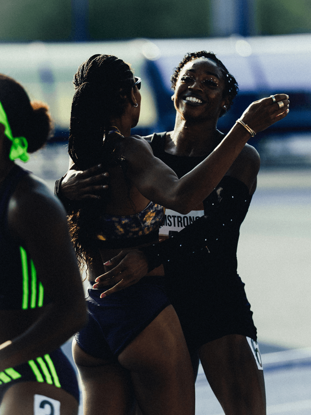 Armstrong embraces a competitor after the race, smiling